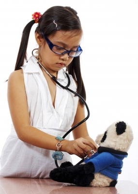 child playing doctor with teddy.jpg